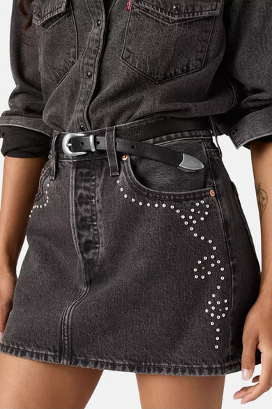 Short dark gray denim skirt from Levi's, adorned with silver-colored studs along the pockets and a black belt.