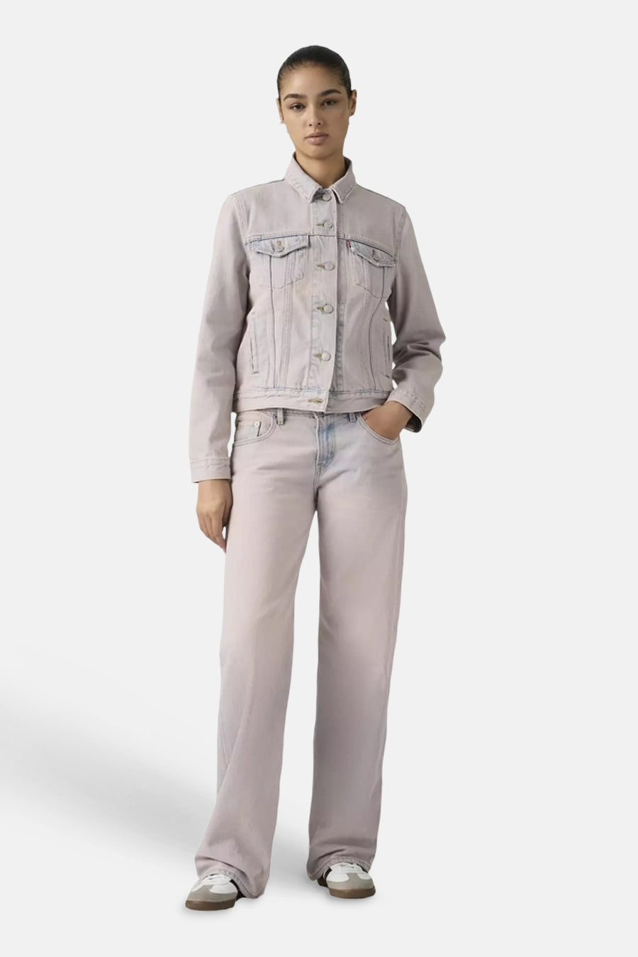 Pantalon rose de couleur de Levi's® à jambes larges, porté par un mannequin avec une veste en jean assortie et des baskets blanches.
