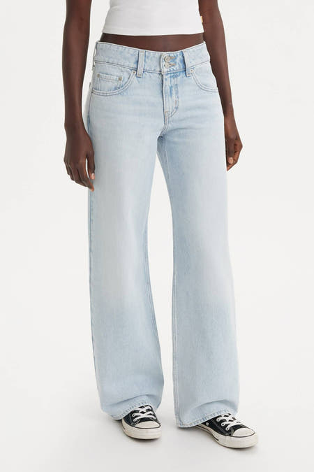 Jean droit bleu clair de Levi's, avec une taille basse et des chaussures en toile noire.