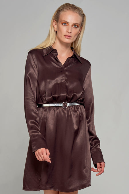 Robe brune à longues manches d'Astrid Black Label, terminée par une ceinture argentée.