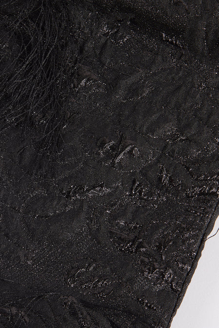 Zwarte handtas van Astrid Black Label, met glanzende, ingeweven patronen en decoratieve franjes.