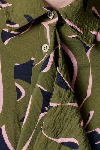 Robe verte avec des manches longues d'Astrid Black Label, avec un motif abstrait et une texture froissée.