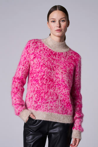 T-shirt rose à col montant d'Astrid Black Label, avec un motif rayé et porté avec un pantalon en cuir noir.