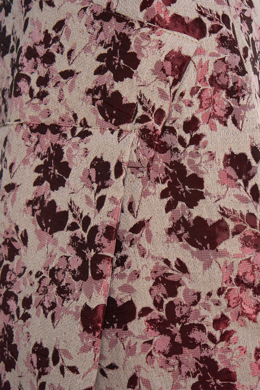 Robe rose d'Astrid Black Label, avec un motif floral et une subtile texture.