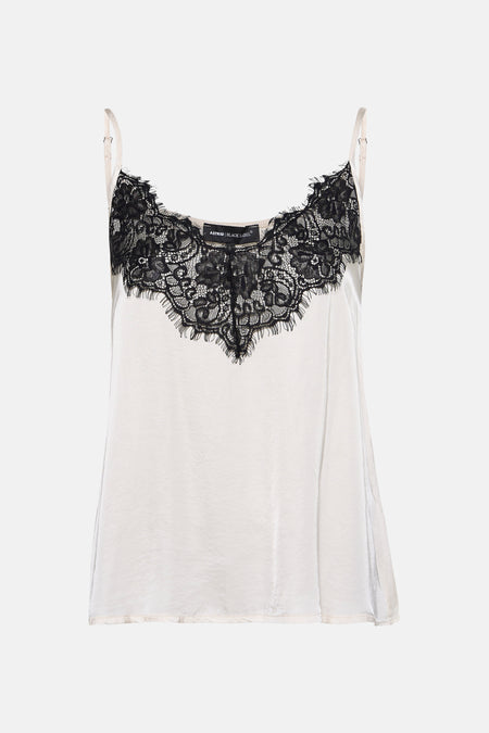 Blouse sans manches écru d'Astrid Black Label, avec des détails en dentelle noire le long de l'encolure.
