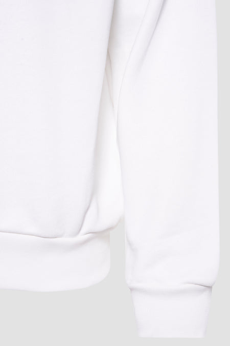 Pull-over blanc de KAOTIKO, avec des manches longues et un bord côtelé.