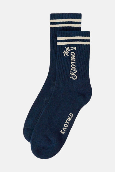 Chaussettes bleues de KAOTIKO, avec des rayures blanches sur le dessus et le logo.