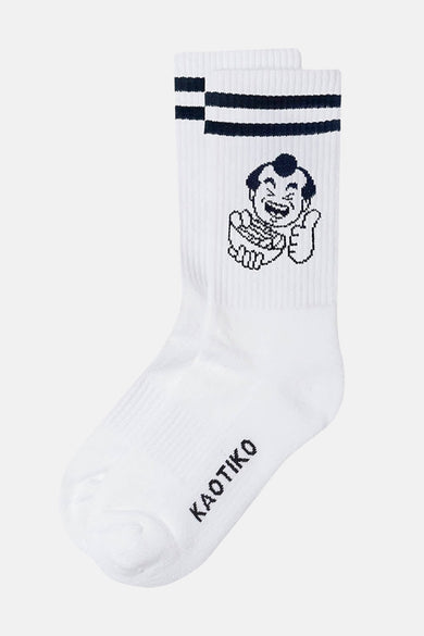 Chaussettes blanches de KAOTIKO avec des bandes bleues foncées sur le dessus et une image de cartoon.