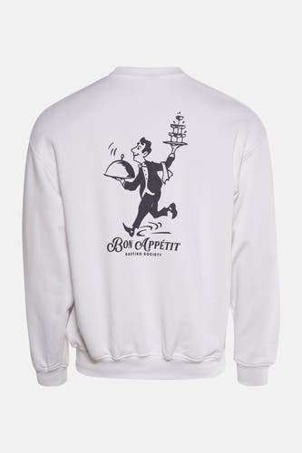 Pull-over blanc de KAOTIKO avec un imprimé d'un serveur et le texte "Bon Appétit" sur le dos.