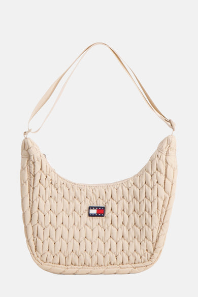 Sac bandoulière écru de TOMMY JEANS, avec un motif de lunettes déchiré et une bandoulière ajustable.