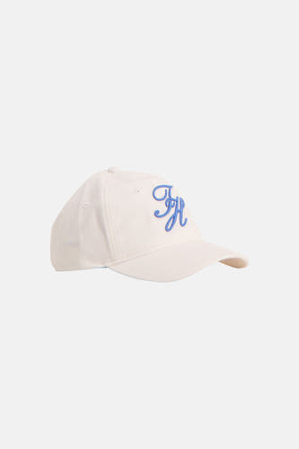 Casquette blanche TOMMY JEANS avec un monogramme TH bleu brodé, vue de profil.