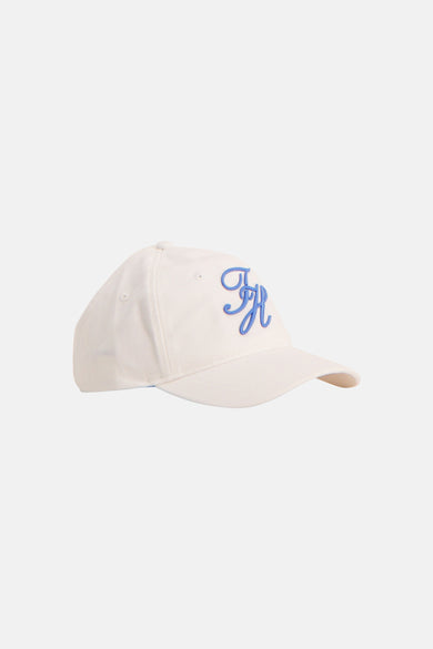 Casquette blanche TOMMY JEANS avec un monogramme TH bleu brodé, vue de profil.