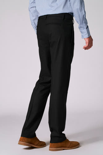 Pantalon de costume noir Bruce & Butler, avec poche arrière, associé à une chemise à motif bleu et des chaussures en cuir de mouton.