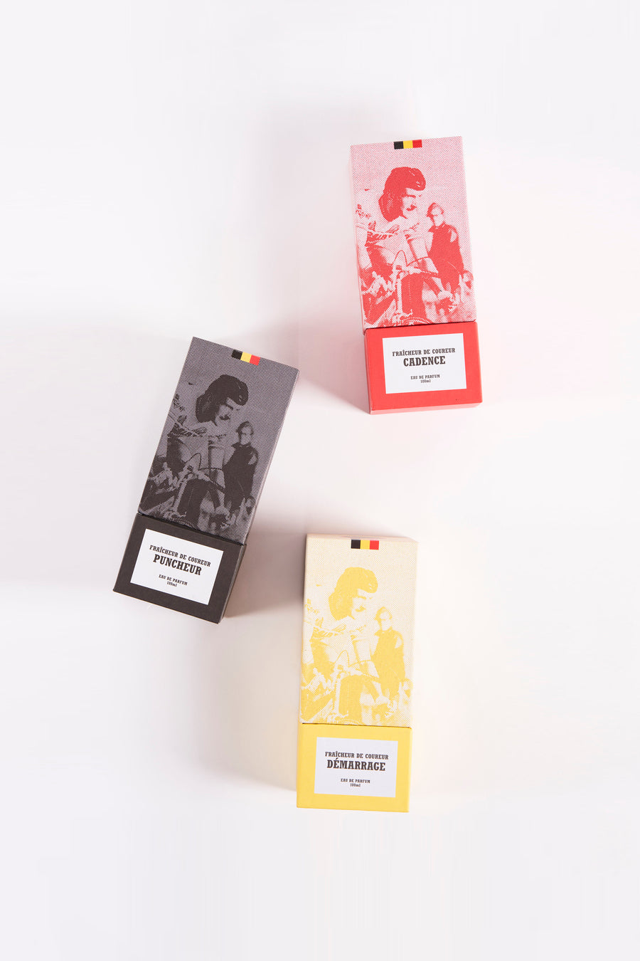 Trois flacons de parfum du Cyclo Club Marcel, chacun avec un design coloré différent et une image d'un cycliste.