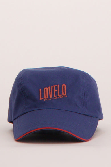 Casquette bleue du Cyclo Club Marcel avec bordure rouge le long de la fermeture éclair et logo sur l'avant.