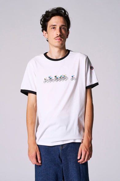 T-shirt blanc à manches courtes de Cyclo Club Marcel, avec une impression de cyclistes et un bord noir autour du col et des manches, porté avec un pantalon en cuir noir.