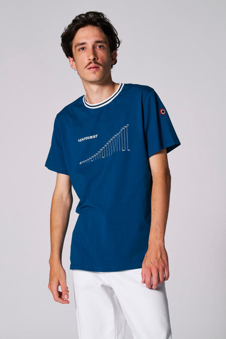 T-shirt bleu à manches courtes de Cyclo Club Marcel, vu de derrière avec un short blanc.