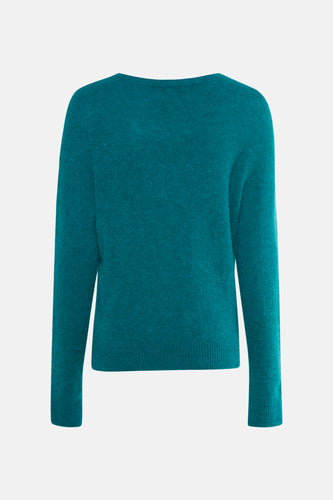 Turquoise wollen trui met lange mouwen.
