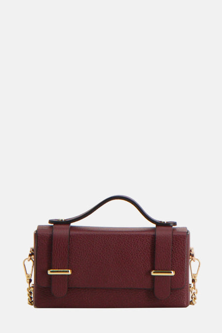 Bordeauxkleurige leren handtas met gouden ketting.