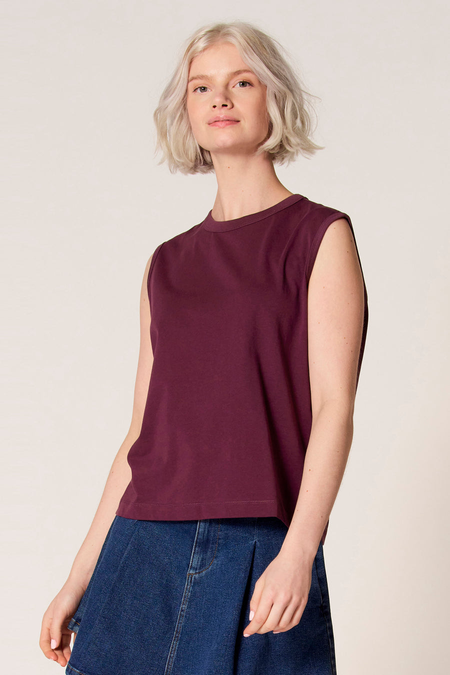 Débardeur violet de Clouds of Fashion, avec un col rond et combiné avec une jupe en jean.