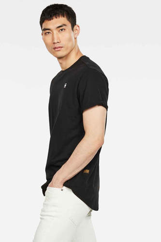 T-shirt noir de G-Star RAW, porté avec un pantalon blanc, en vue latérale.