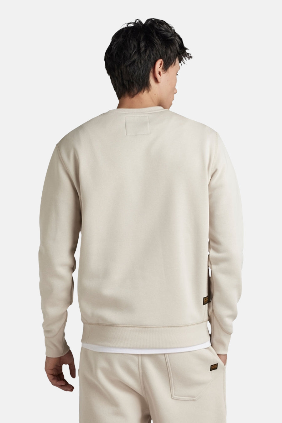 Ecrukleurige sweater met ronde hals van G-Star RAW, gezien van achteren, met subtiel label detail.