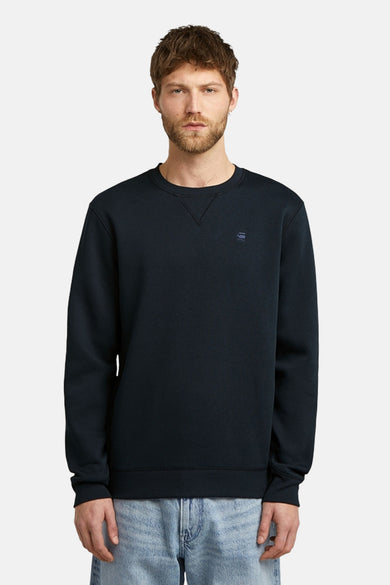Pull-over bleu avec col rond de G-Star RAW, vu de derrière, associé à un jean bleu clair.
