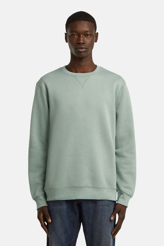Sweater vert de G-Star RAW avec un col rond, vu de derrière, porté avec un jean.
