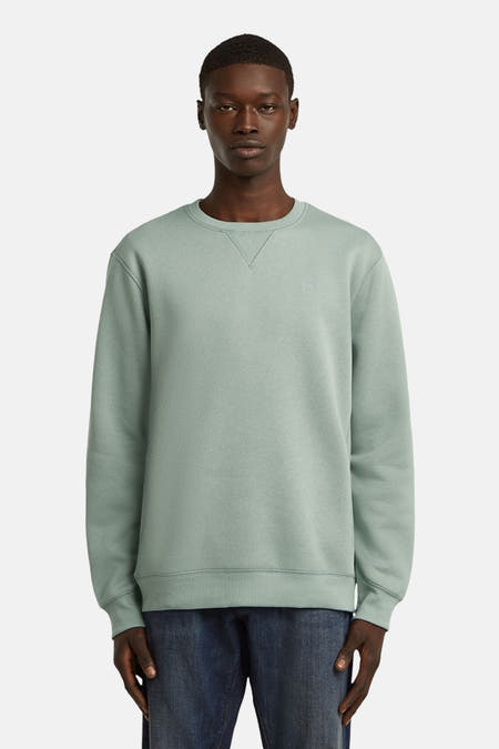 Sweater vert de G-Star RAW avec un col rond, vu de derrière, porté avec un jean.