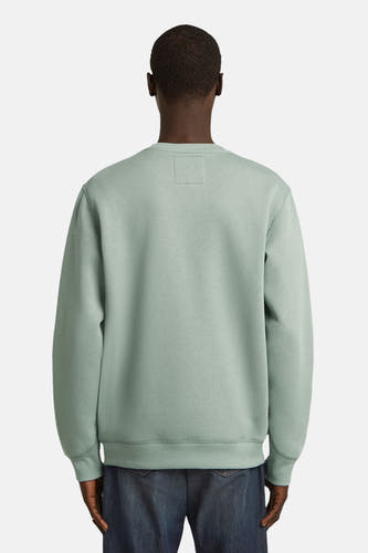 Groene sweater met ronde hals van G-Star RAW, gezien van achteren, gedragen met een jeansbroek.
