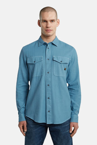 Chemise bleue à manches longues de G-Star RAW, avec deux poches po po et une fermeture à boutons.