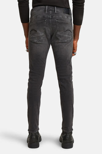 Jean skinny gris G-Star RAW, vue arrière avec poches visibles et chaussures noires.