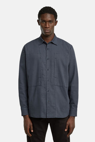 Chemise bleue à manches longues de G-Star RAW, avec fermeture à boutons visible et poches droites sur la poitrine.