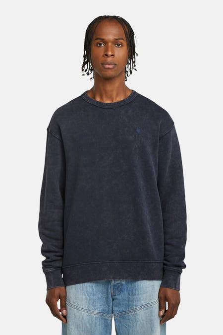 Pull-over bleu de G-Star RAW, avec des manches longues et porté avec un jean.