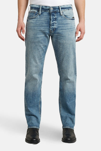 Jean fuselé bleu de G-Star RAW, avec texture denim et poches arrière.