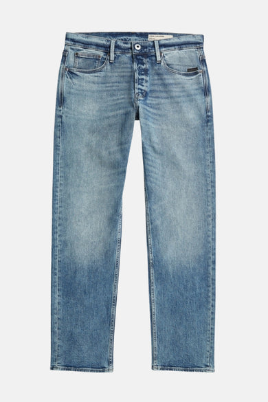Jeans fuselés en denim bleu de G-Star RAW, avec un délavage stone wash et une fermeture à boutons.