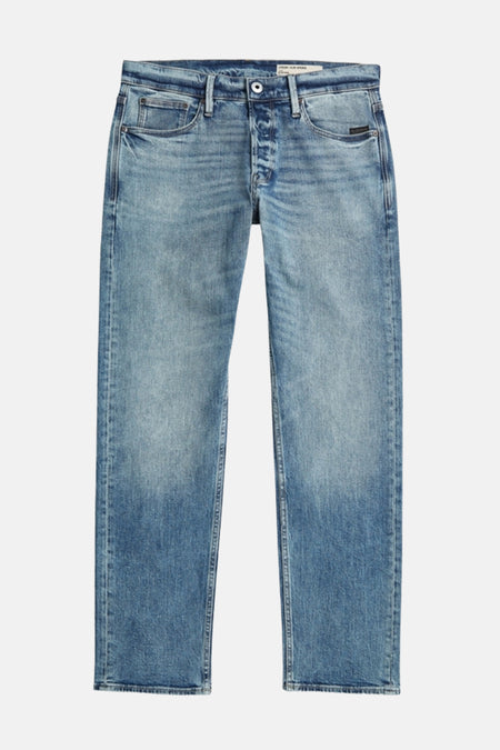 Jeans fuselés en denim bleu de G-Star RAW, avec un délavage stone wash et une fermeture à boutons.