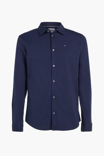 Chemise bleue à manches longues de TOMMY JEANS, avec col boutonné et un logo brodé sur la poitrine.