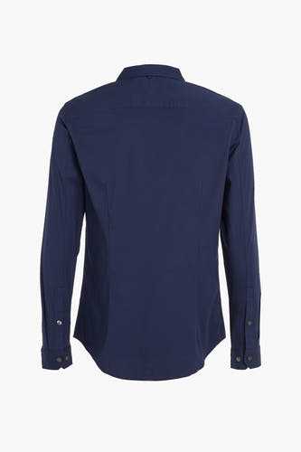 Chemise bleue à manches longues de TOMMY JEANS, dos avec détails de boutons sur les poignets.