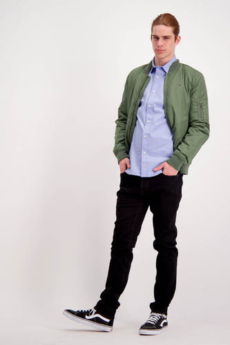 Bleu marine, chemise à longues manches de TOMMY JEANS, portée avec un blouson kaki et des jeans noirs.