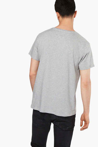 T-shirt gris de TOMMY JEANS, vue sur le dos, associé à des jeans noirs.