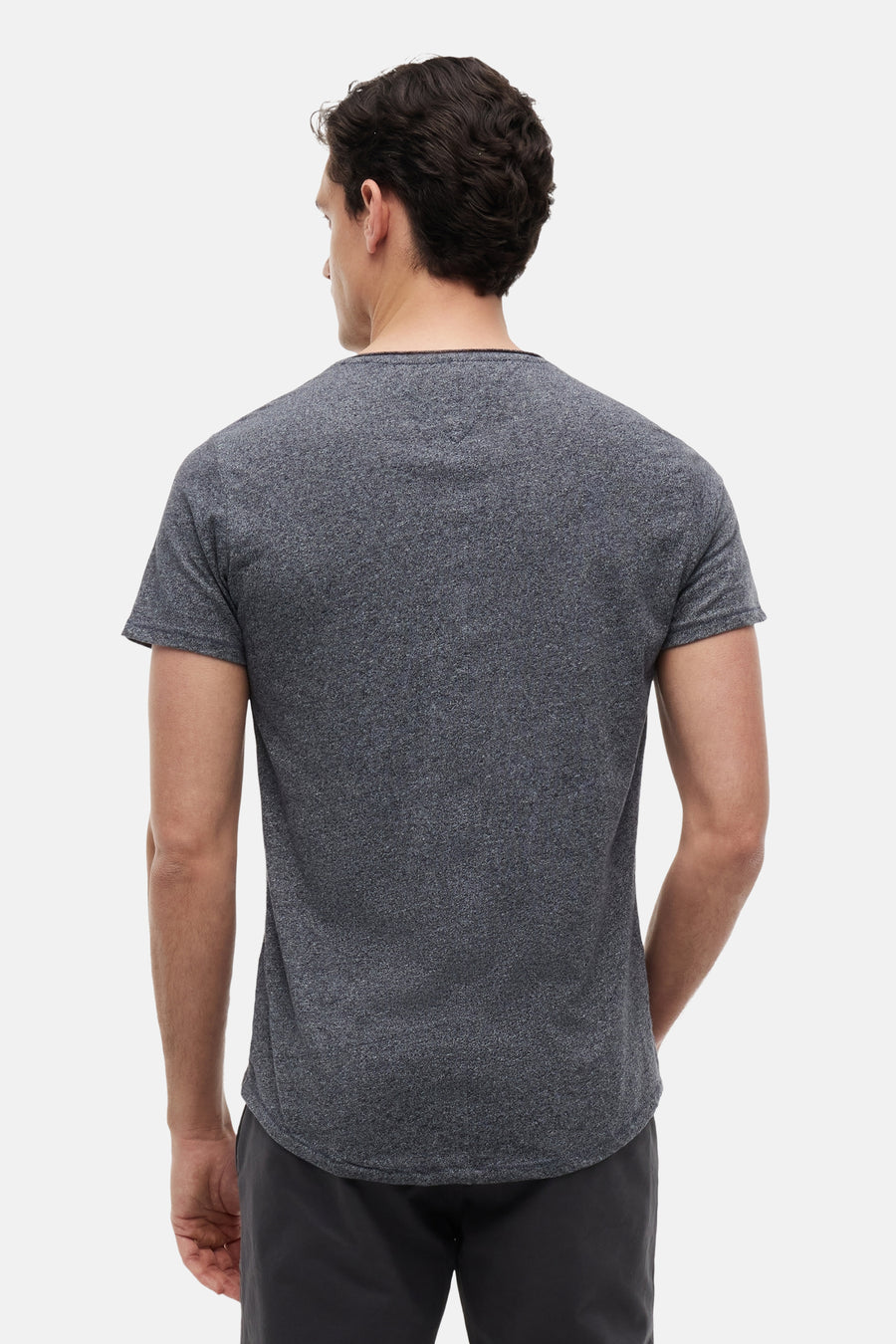 T-shirt gris chiné à manches courtes, bordure noire et ourlet arrondi de TOMMY JEANS, vue arrière d'un homme.