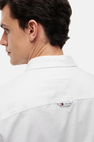 Chemise blanche à manches longues TOMMY JEANS, vue de dos avec petite étiquette de marque dans le dos.