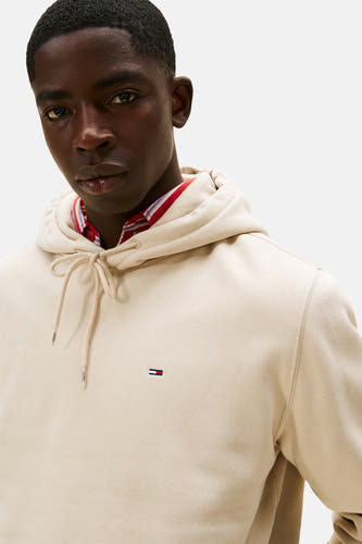 Gilet beige avec capuche de TOMMY JEANS, avec des cordons et un petit logo sur la poitrine.