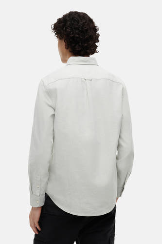 Chemise vert clair à manches longues de TOMMY JEANS, avec empiècement et pli dans le dos, portée par un homme de dos.