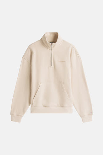 Gilet beige de TOMMY JEANS, avec une fermeture à glissière courte et un poche.