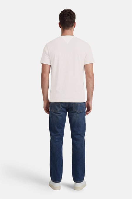 Witte korte mouwen T-shirt van TOMMY JEANS, achterzijde weergegeven, gladde stof, gestreept denim broek, witte sneakers