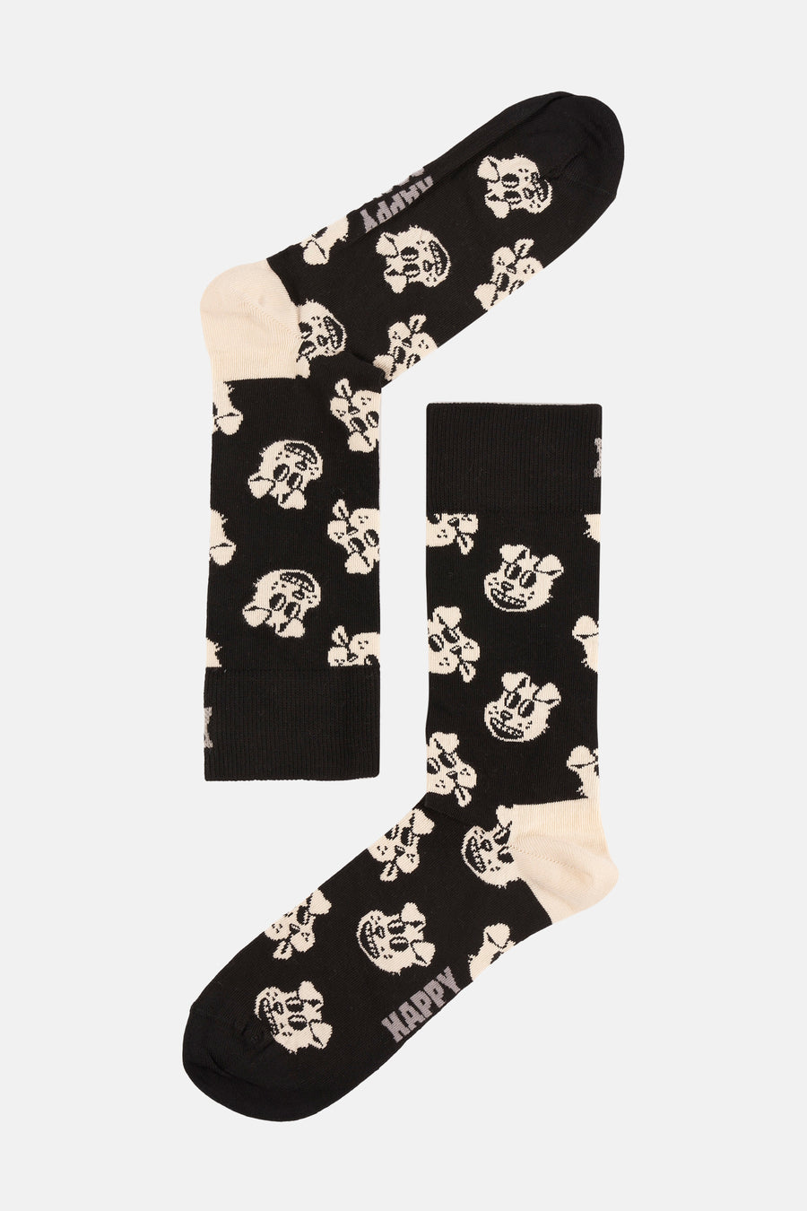 Chaussettes noires de Happy Socks®, avec un motif de têtes de mort blanches.