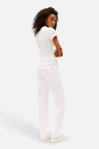 Ecru T-shirt met korte mouwen van TOMMY JEANS, gedragen met een witte jeans en sneakers.