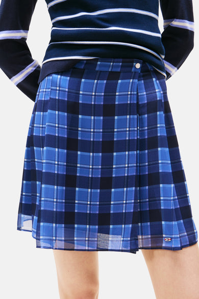 Jupe courte bleue de TOMMY JEANS, avec un motif à carreaux tartan et un détail de nœud.